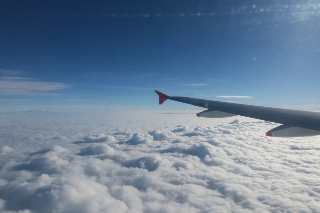 an airplane wing above the clouds