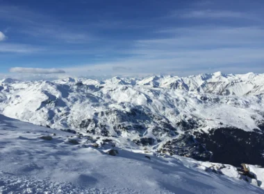 a snowy mountain range with blue sky