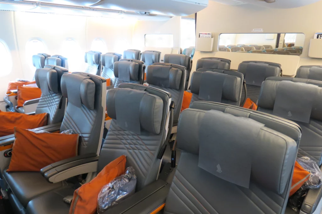 a row of grey seats in an airplane