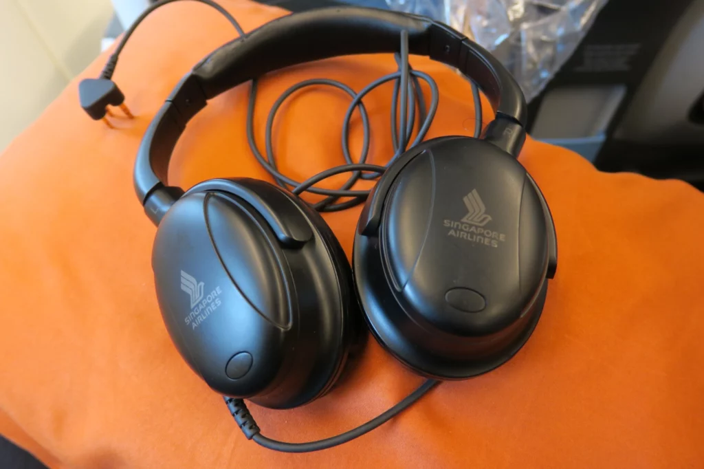 a pair of black headphones on an orange surface