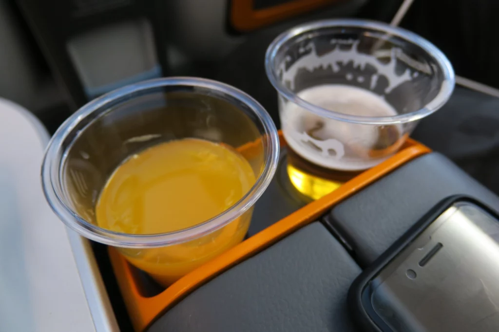 two plastic cups of liquid in a tray