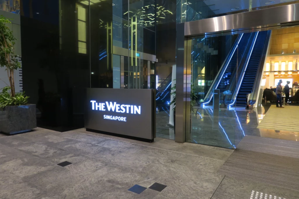 a glass elevator with a sign in front of it