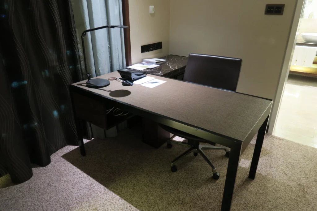 a desk with a chair and a lamp