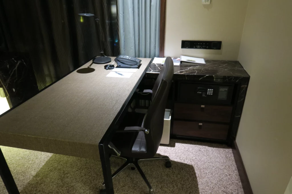 a desk with a chair and a computer