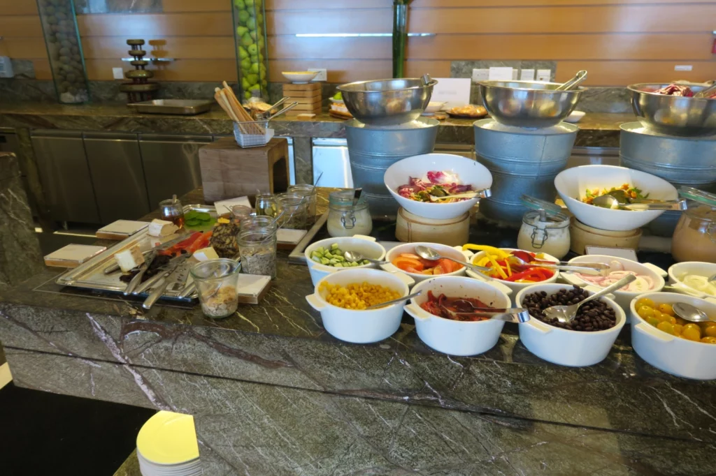 a buffet table with bowls of food