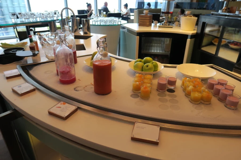 a table with fruit and juices on it