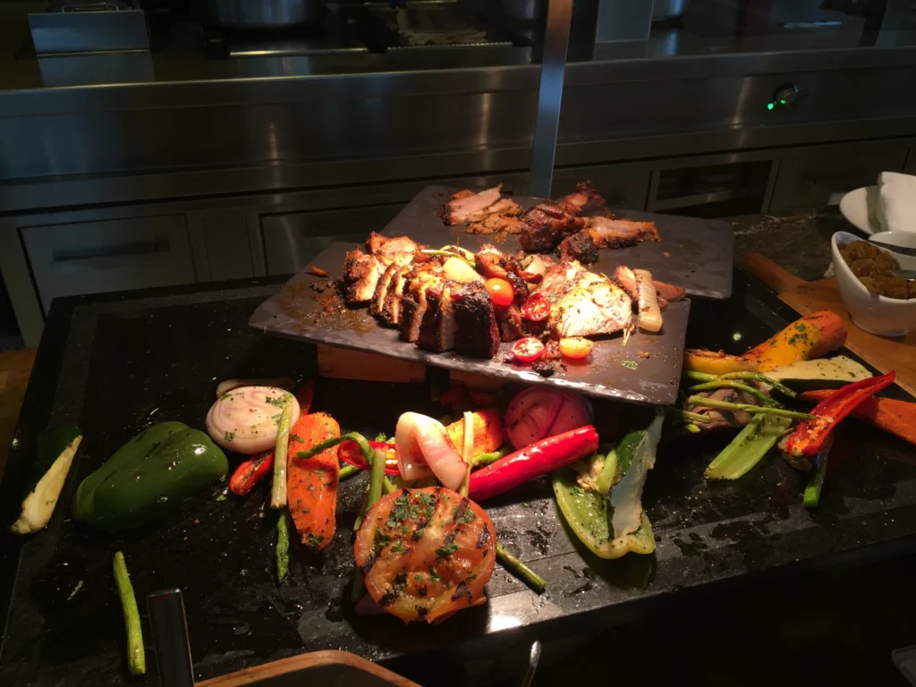 a large pile of meat and vegetables on a table