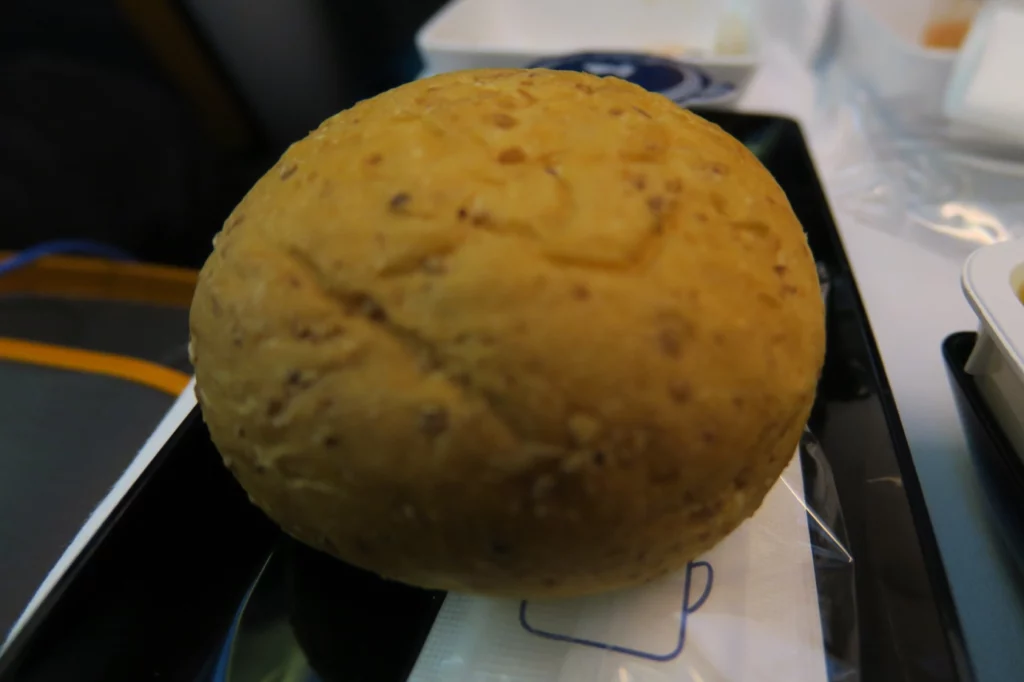 a round brown object on a black plate