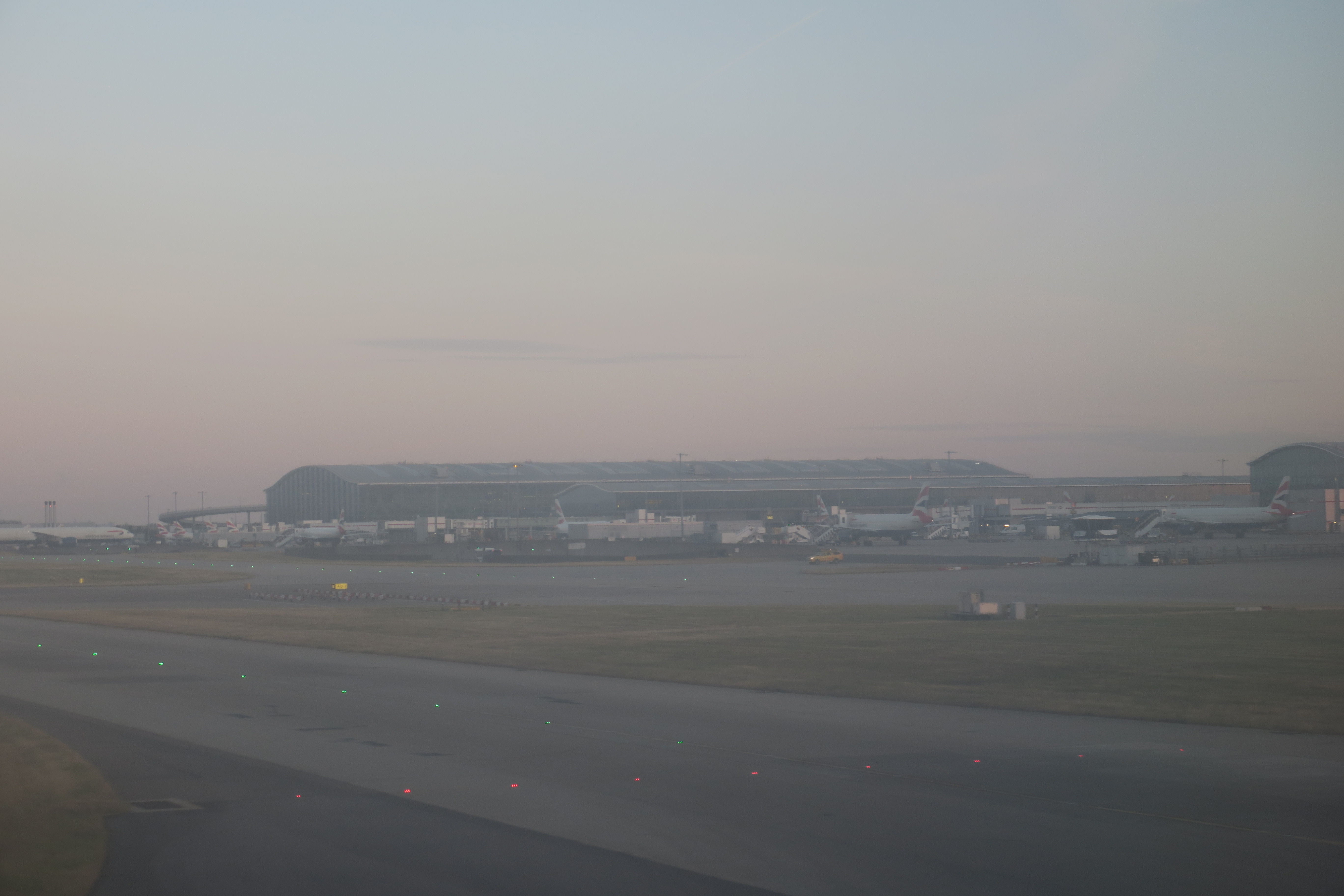 an airport with a large building and runway