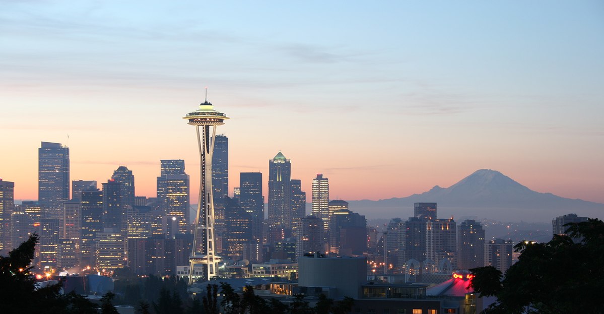 Space Needle skyline with a tall tower and a mountain in the background