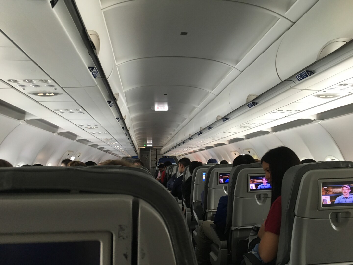 a group of people sitting in an airplane