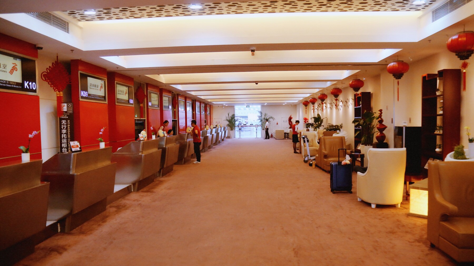 a long hallway with chairs and people in it