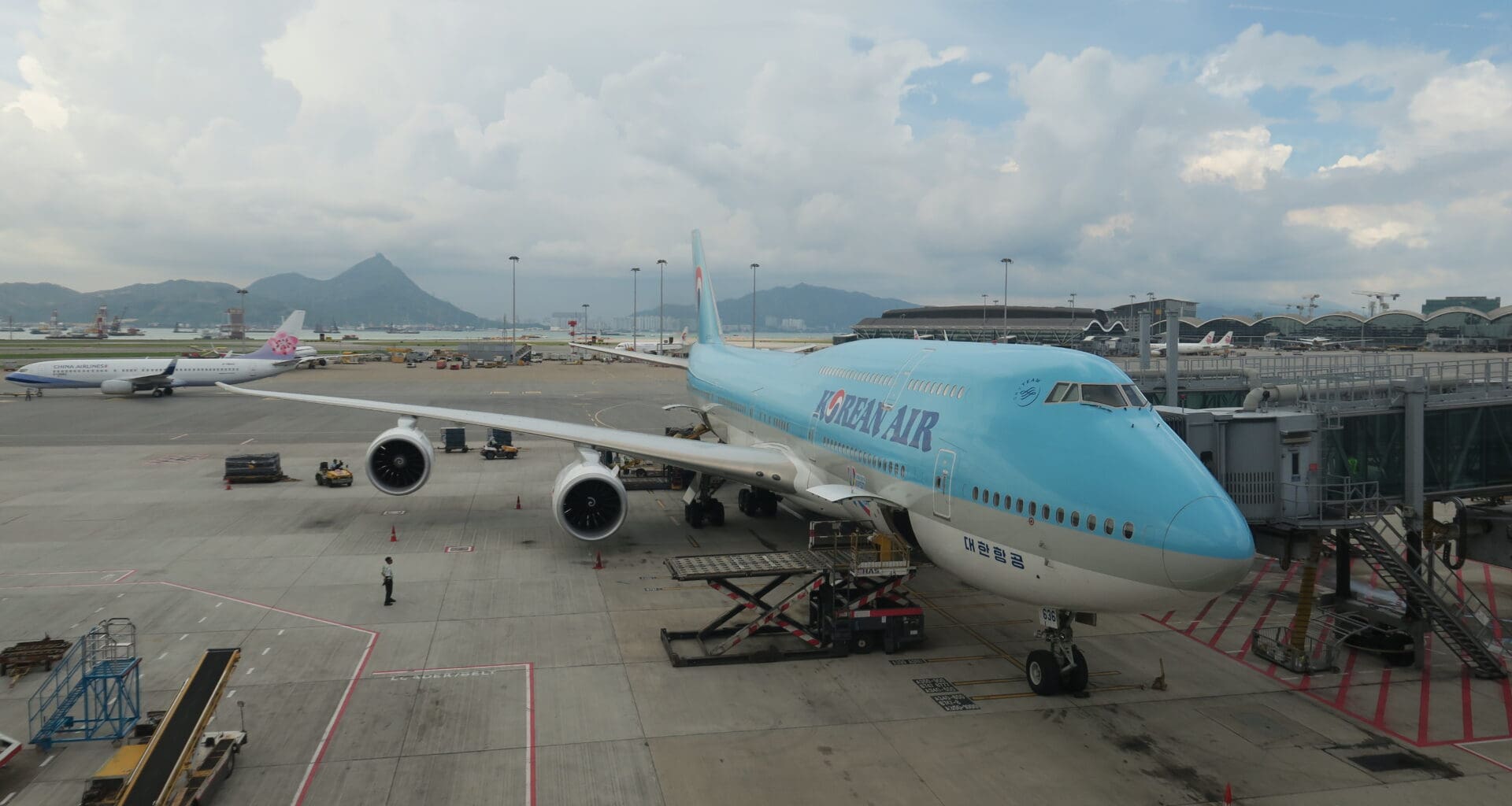 a blue airplane on a tarmac