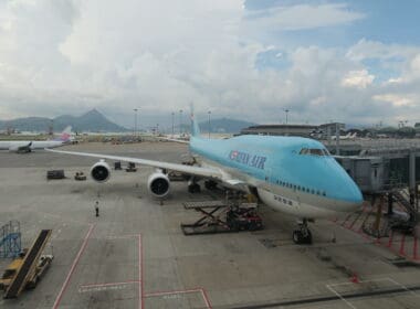 a blue airplane on a tarmac