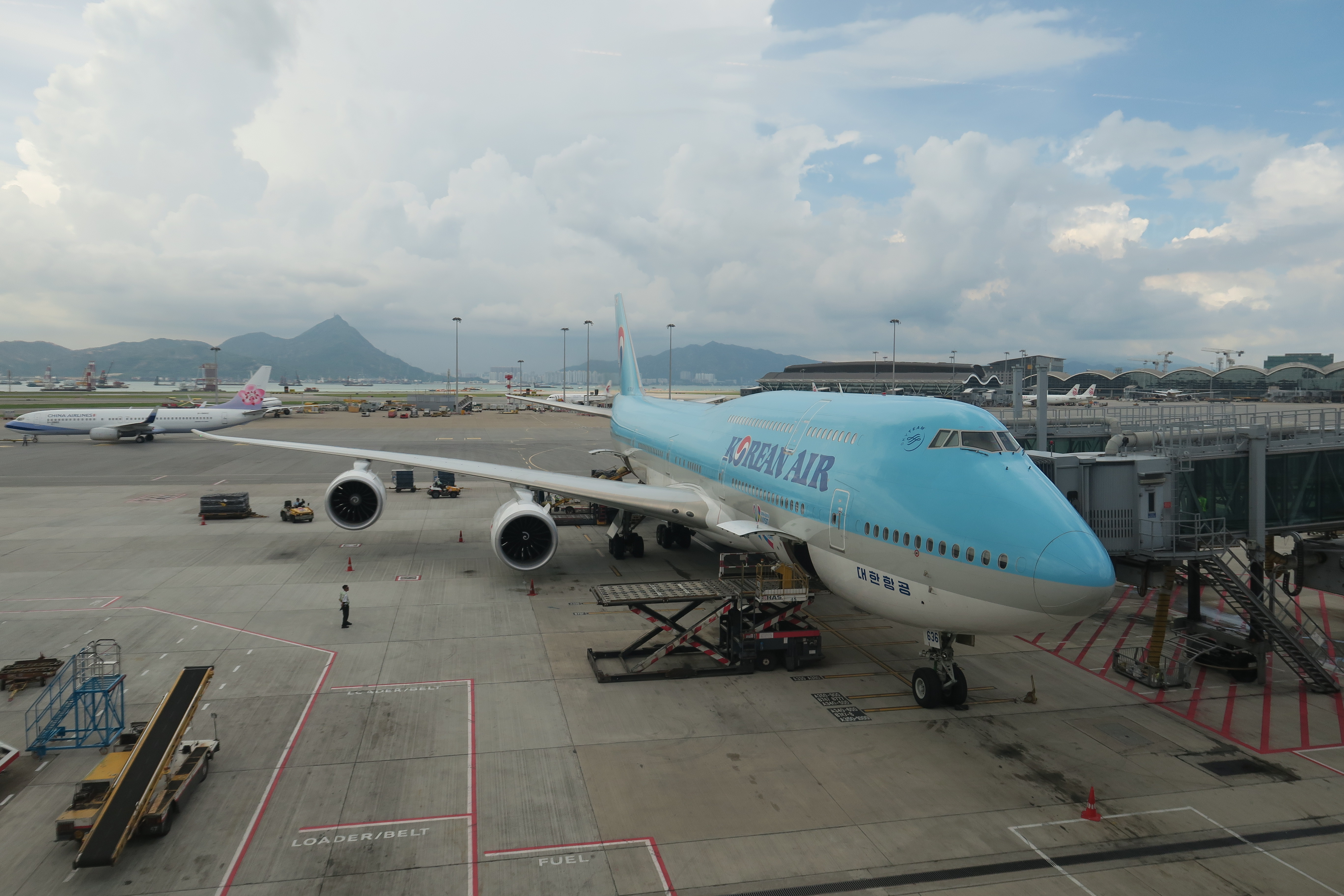 a blue airplane on a tarmac