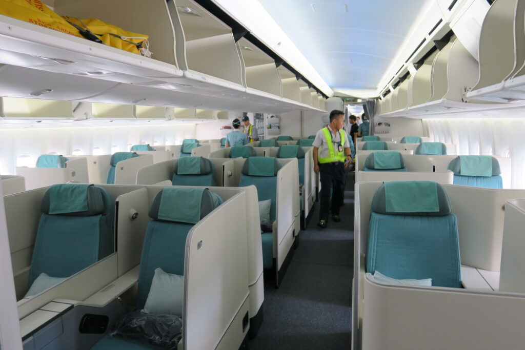 a group of people walking in an airplane