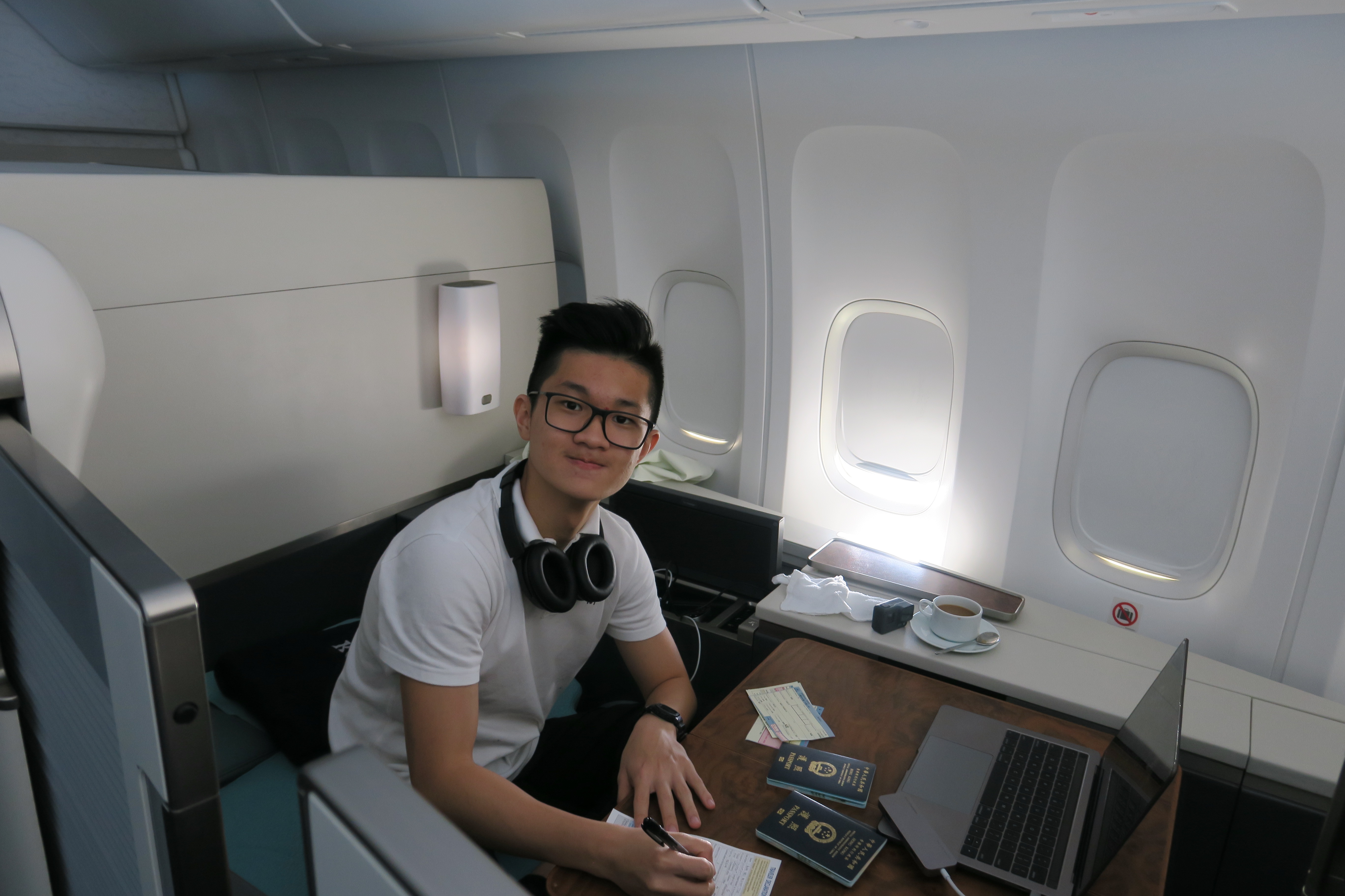 a man sitting at a desk with a laptop and a notebook