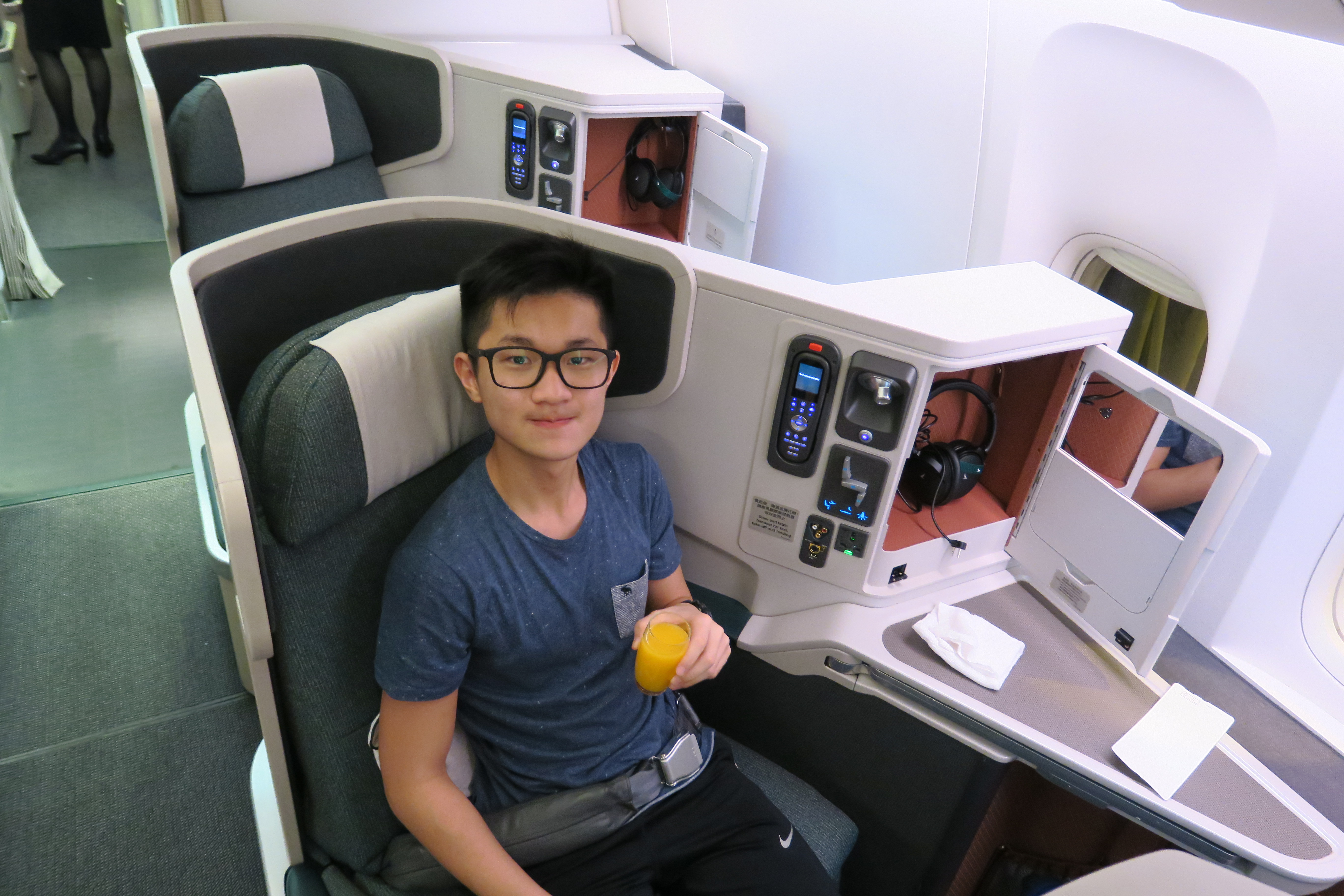 a man sitting in a chair with a glass of juice