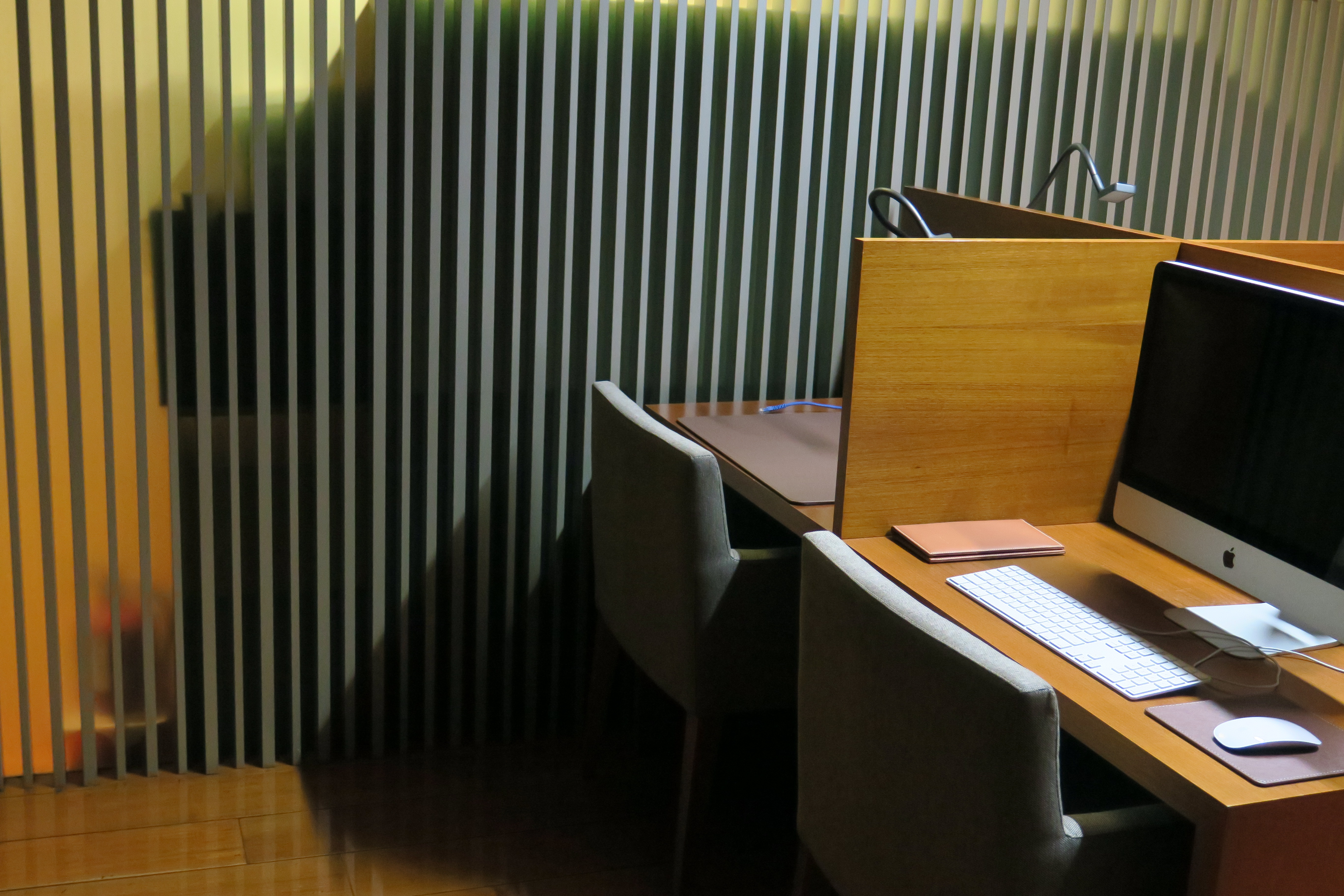 a desk with a computer and a desk with a keyboard