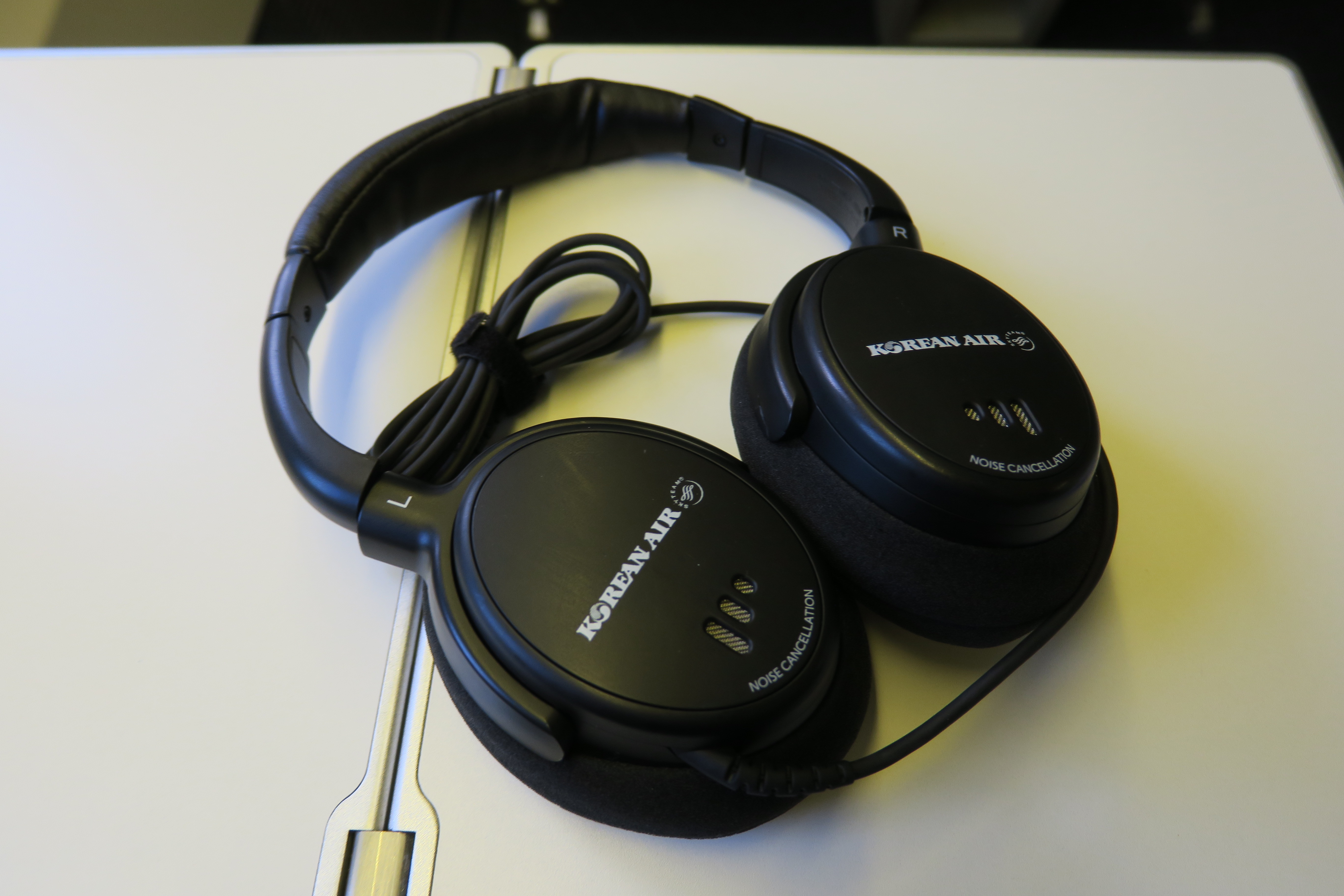 a pair of black headphones on a white surface