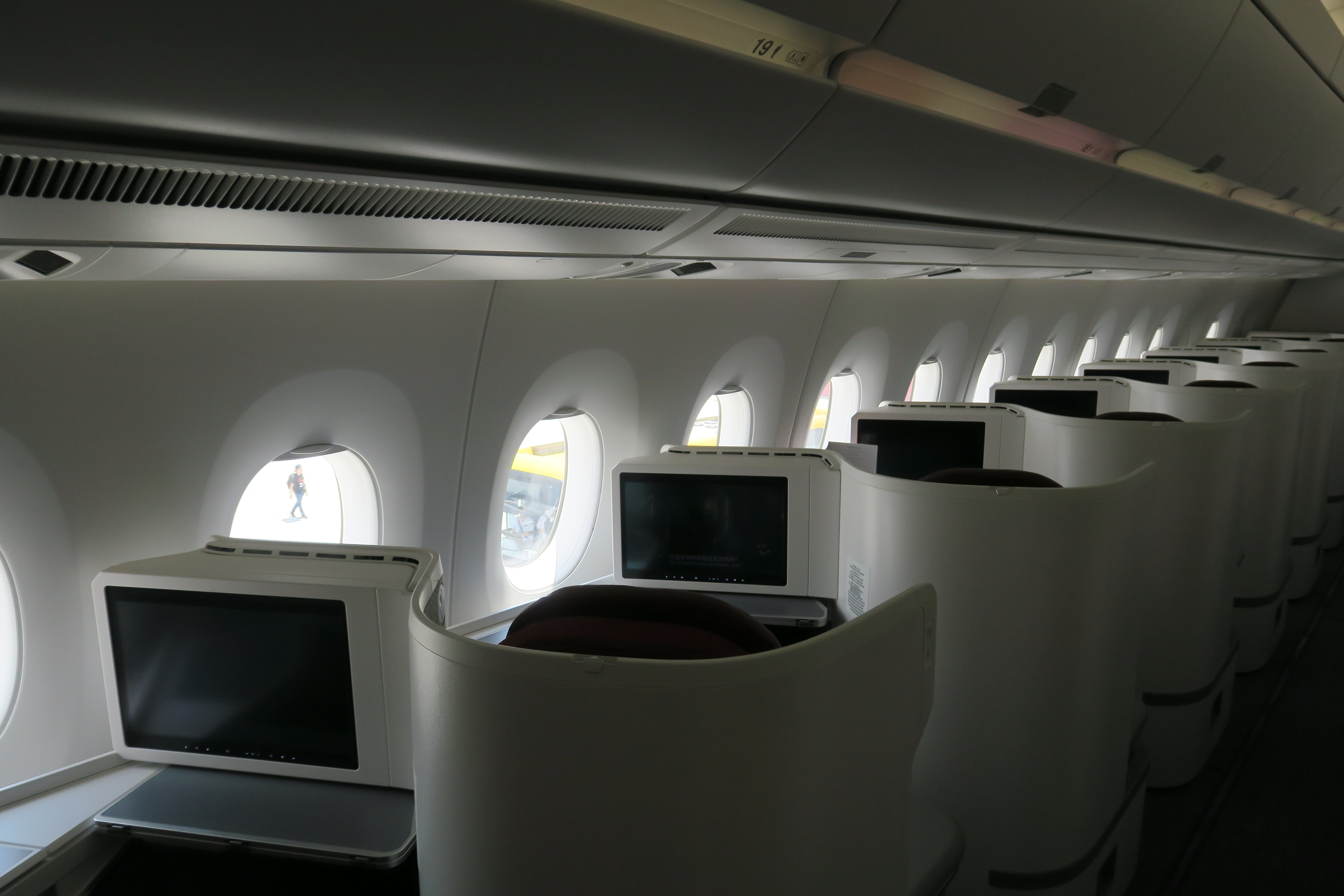 a row of seats with monitors on the side