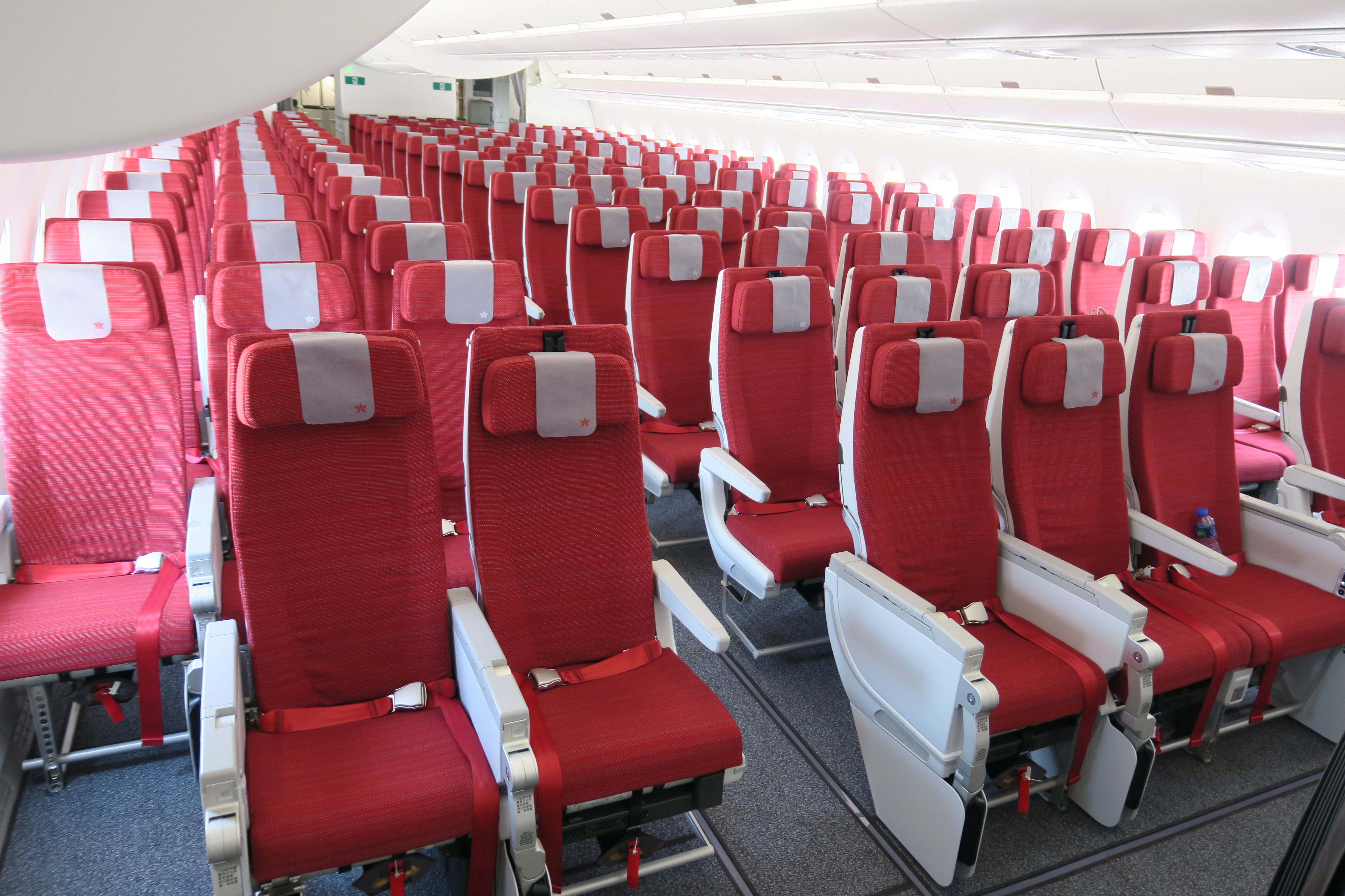 a row of red seats in an airplane