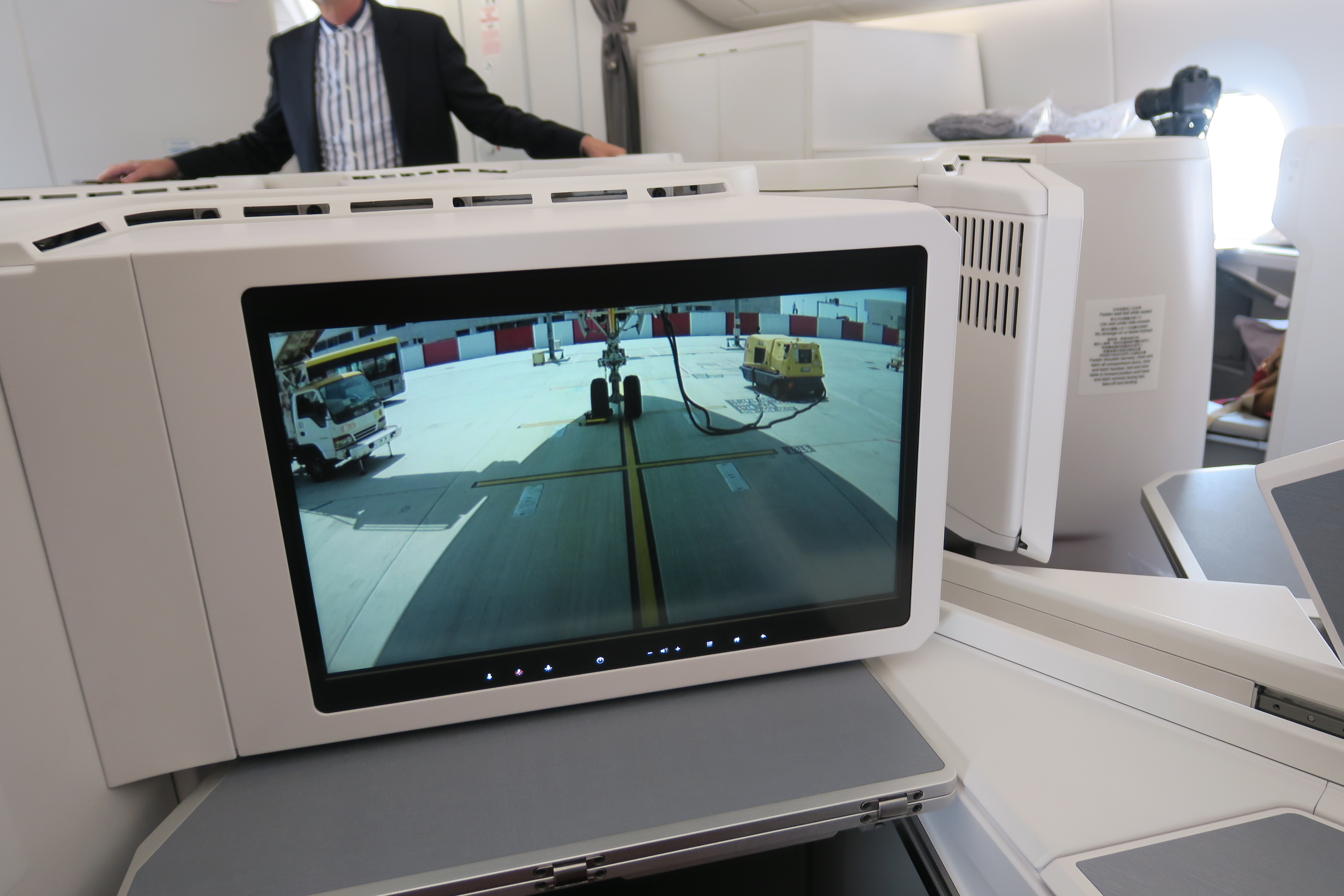 a man standing behind a monitor