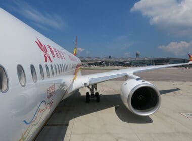 a white airplane with red writing on it