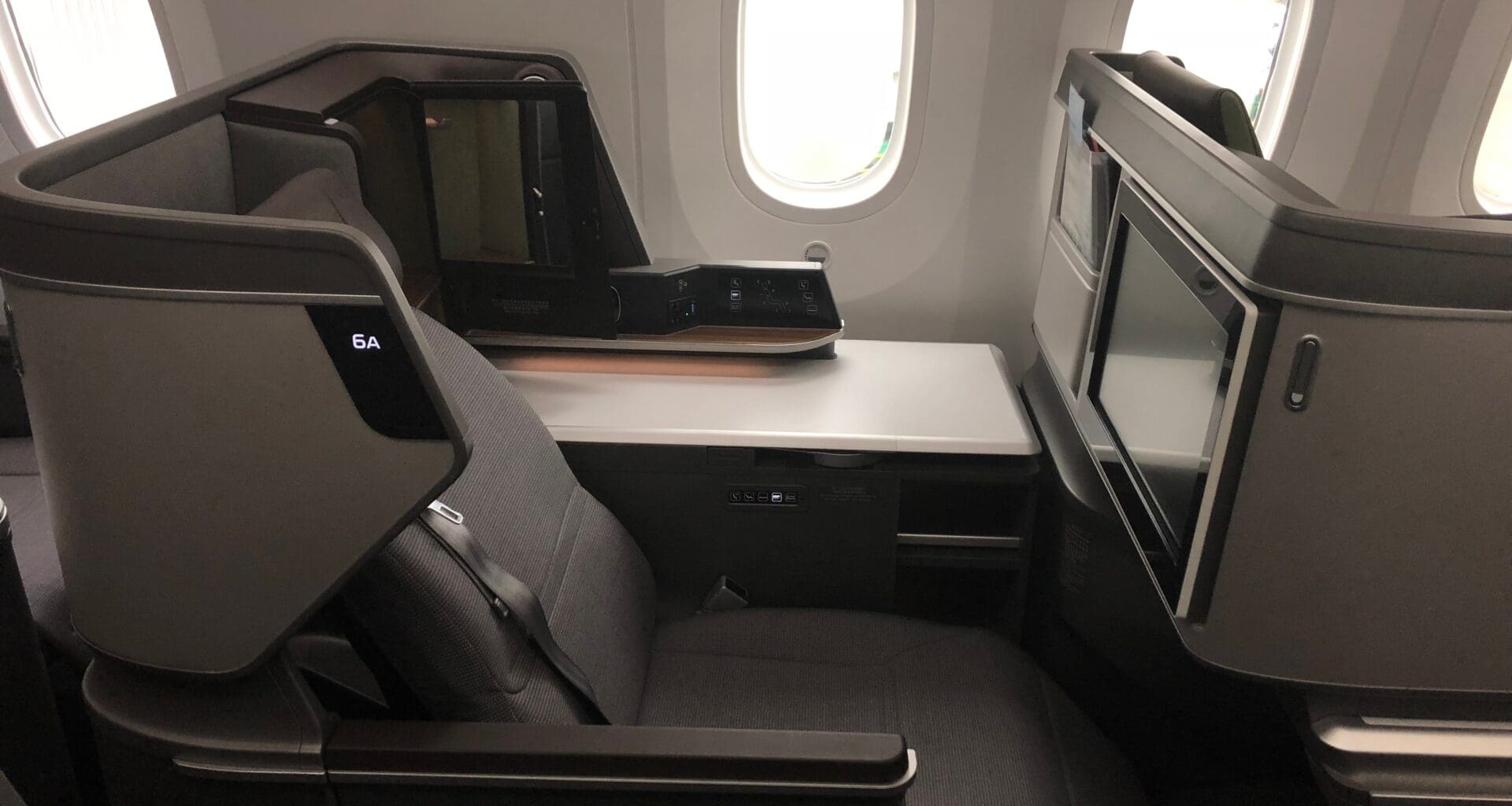 a seat with a monitor on the side