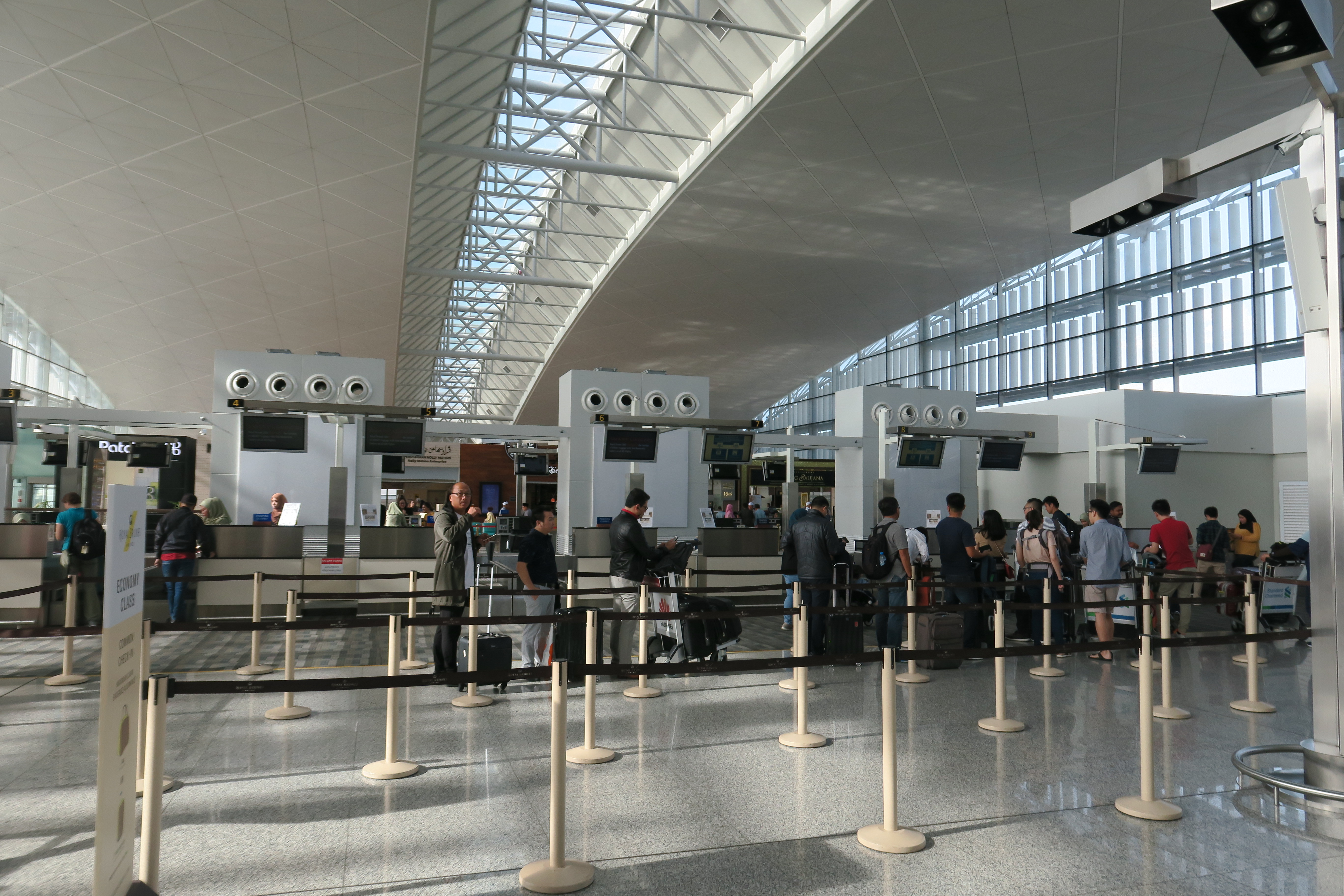 people standing in a line at an airport