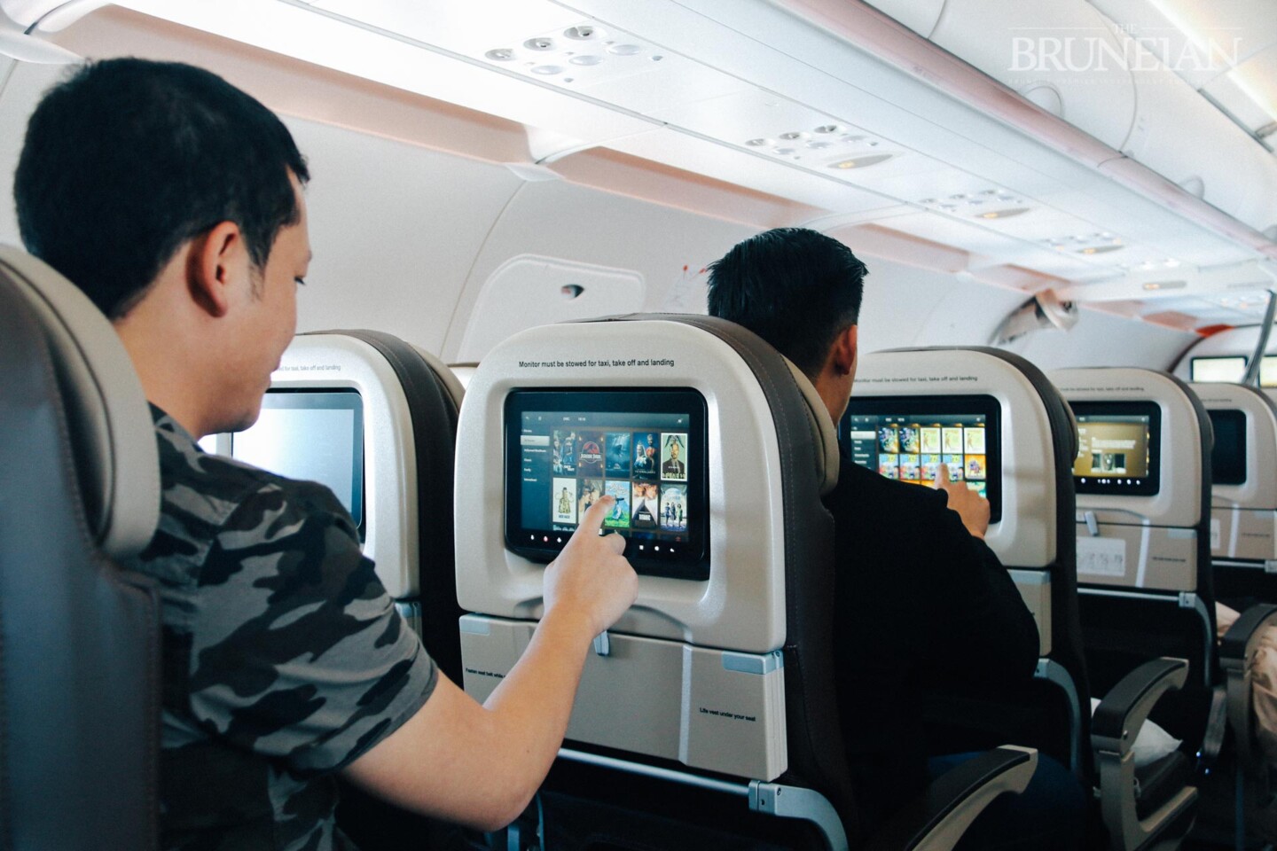 a group of men sitting in an airplane