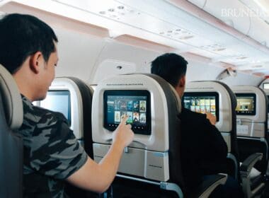 a group of men sitting in an airplane