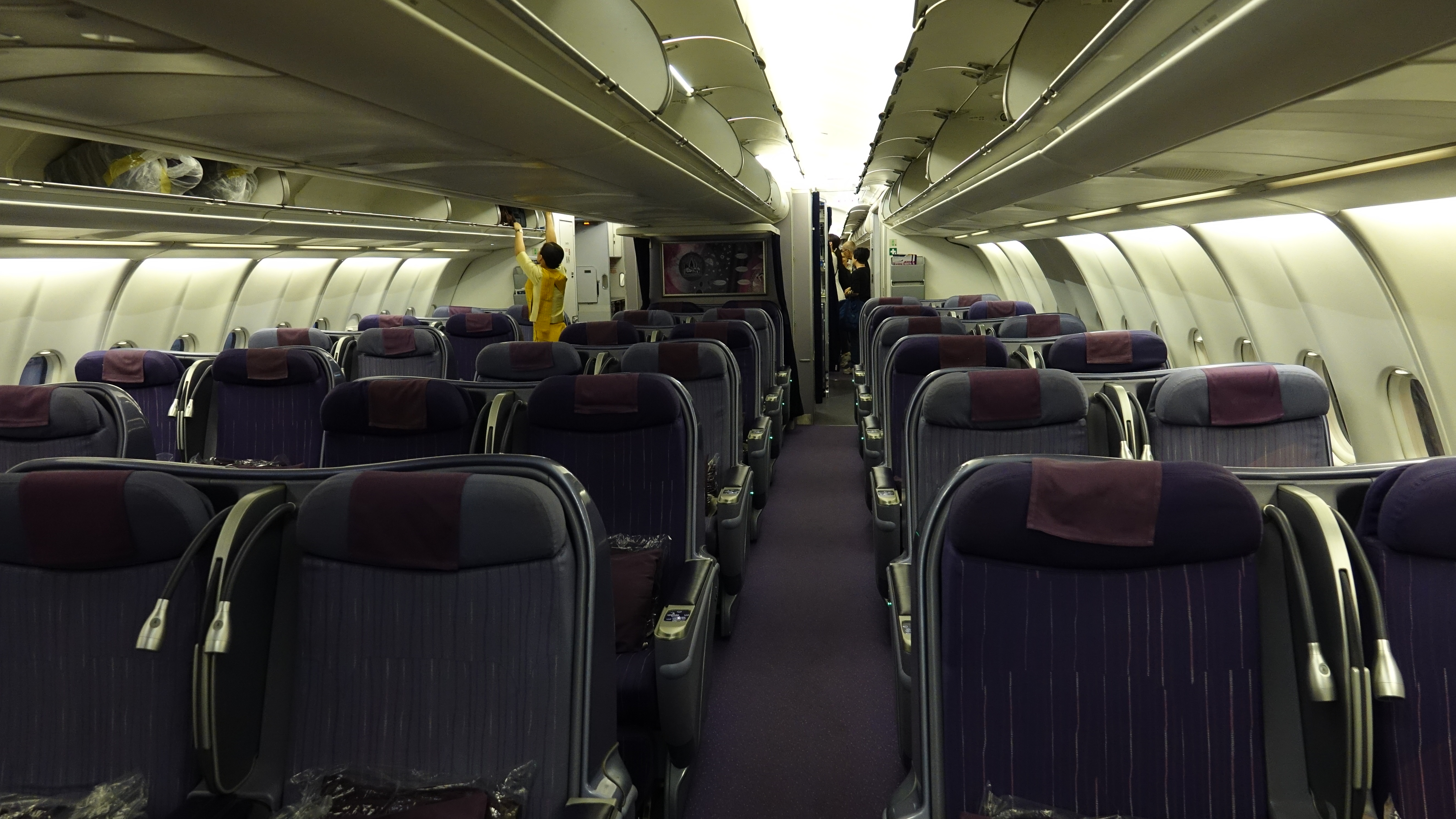 an airplane with seats and people in the background