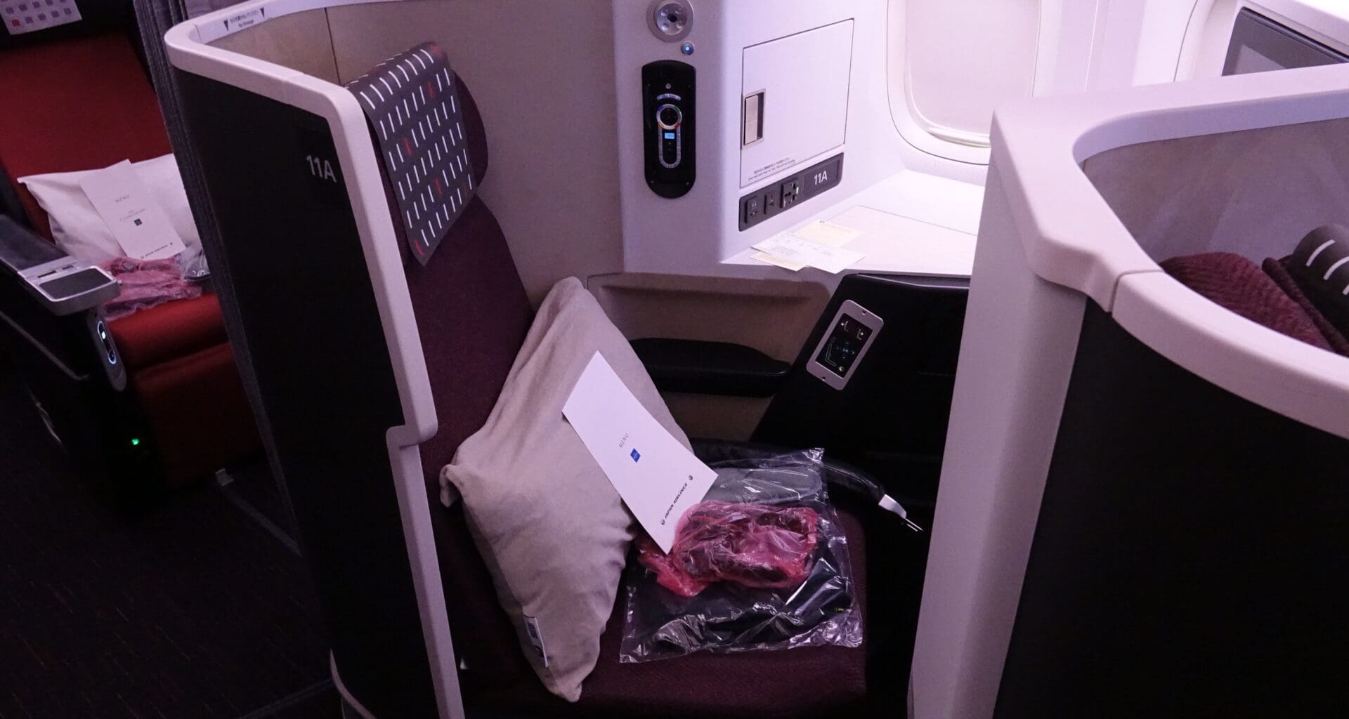 a seat with a pillow and a pillow in the middle of a seat