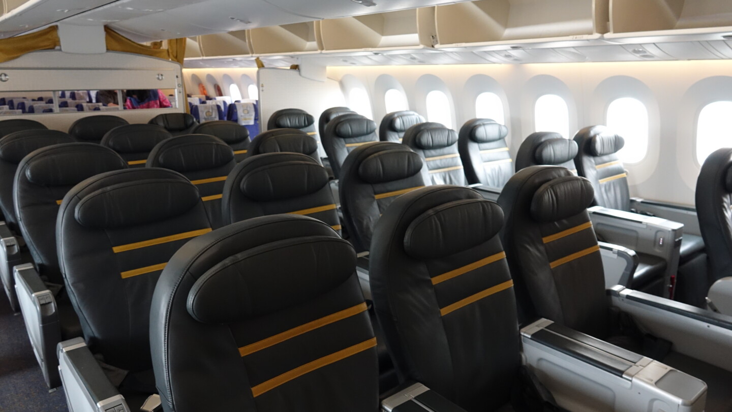 a row of black seats in an airplane