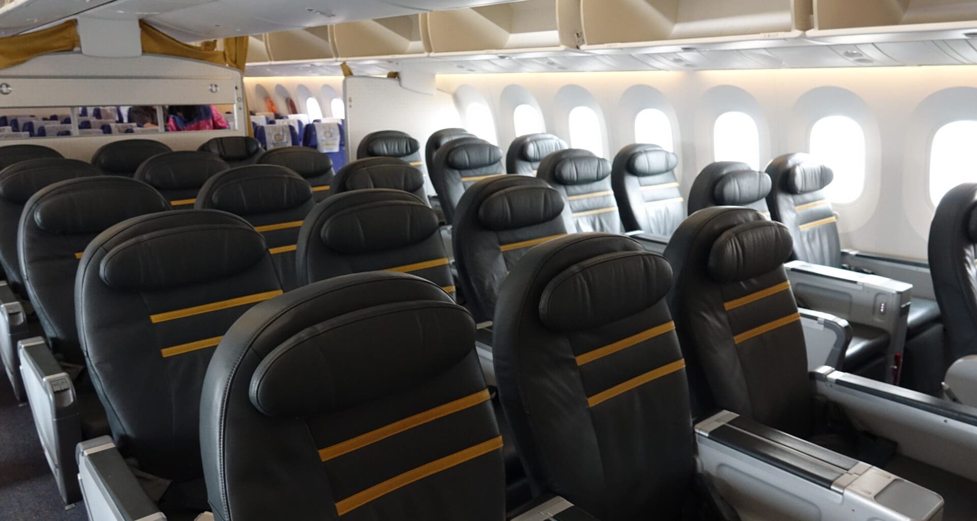 a row of black seats in an airplane