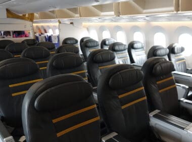 a row of black seats in an airplane