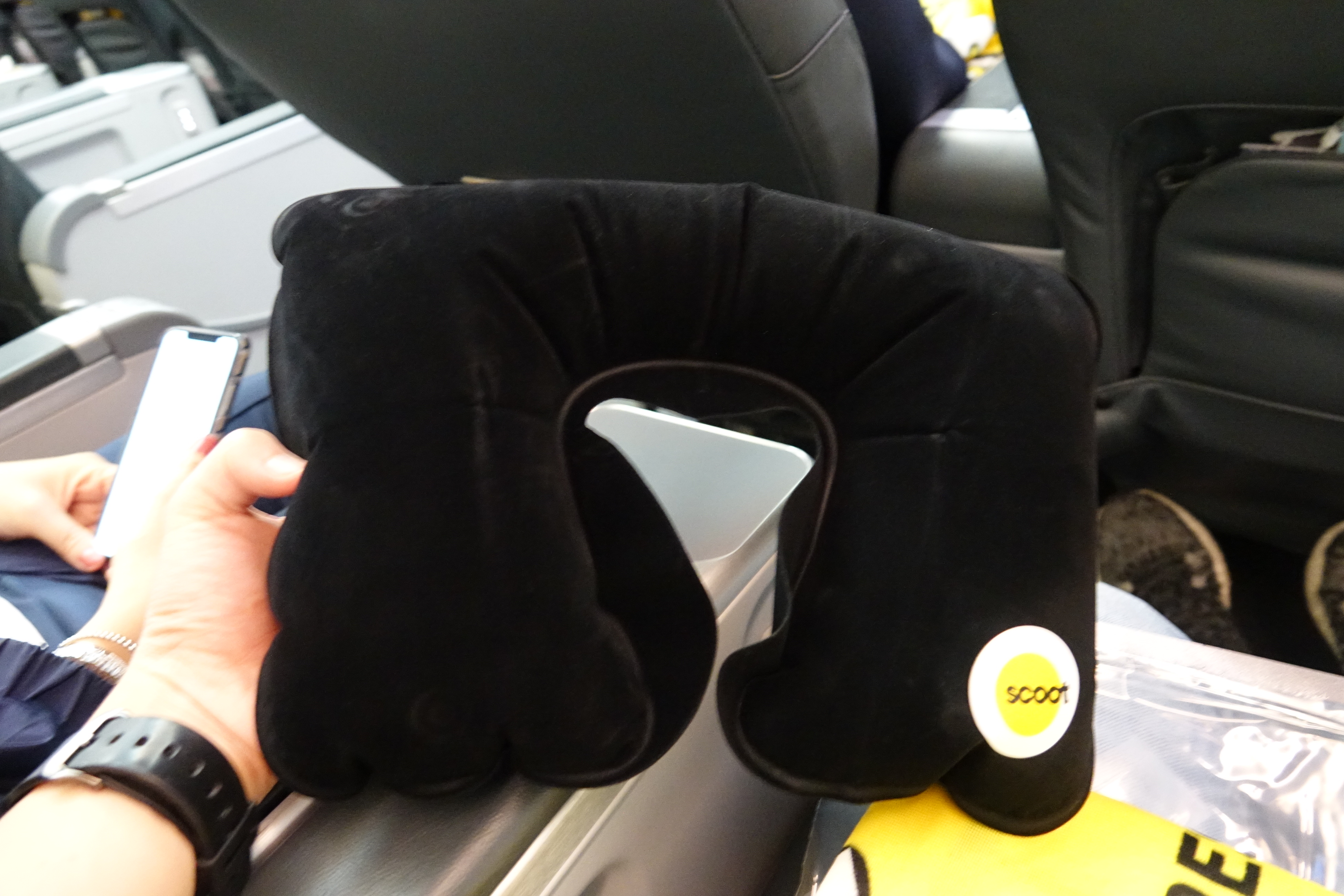 a black neck pillow on a plane