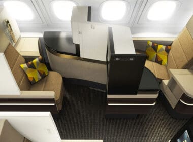 an airplane cabin with a desk and chairs