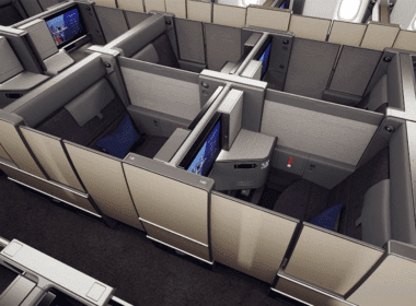 an airplane cabin with a few monitors