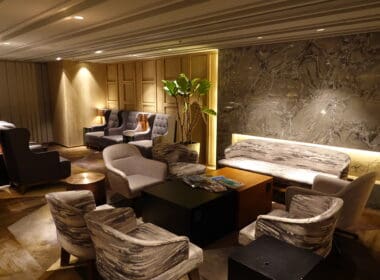 a room with a couch and chairs