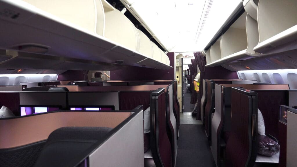 a room with rows of seats and a person in the background