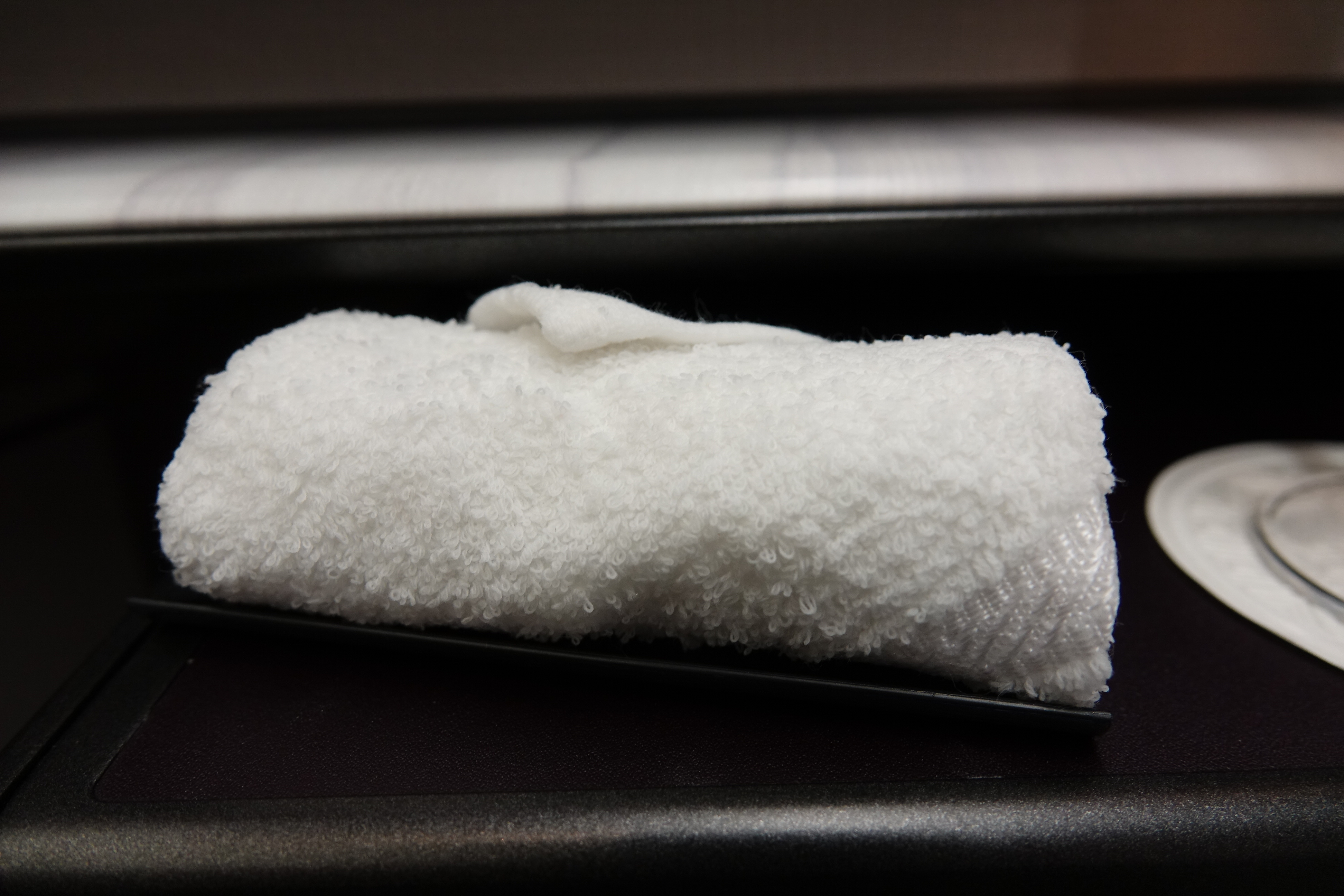 a white towel on a black tray