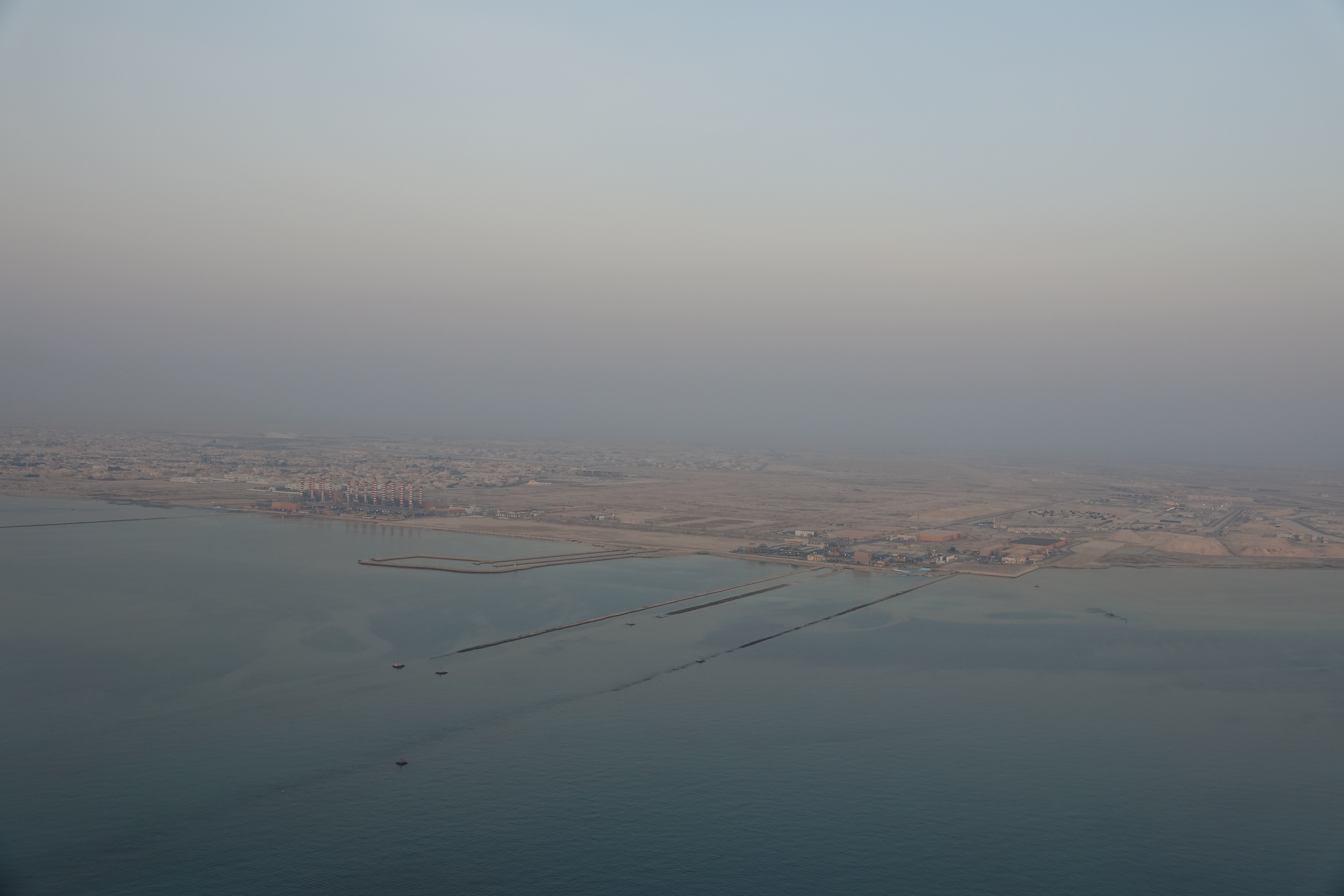 a large body of water with a city in the distance