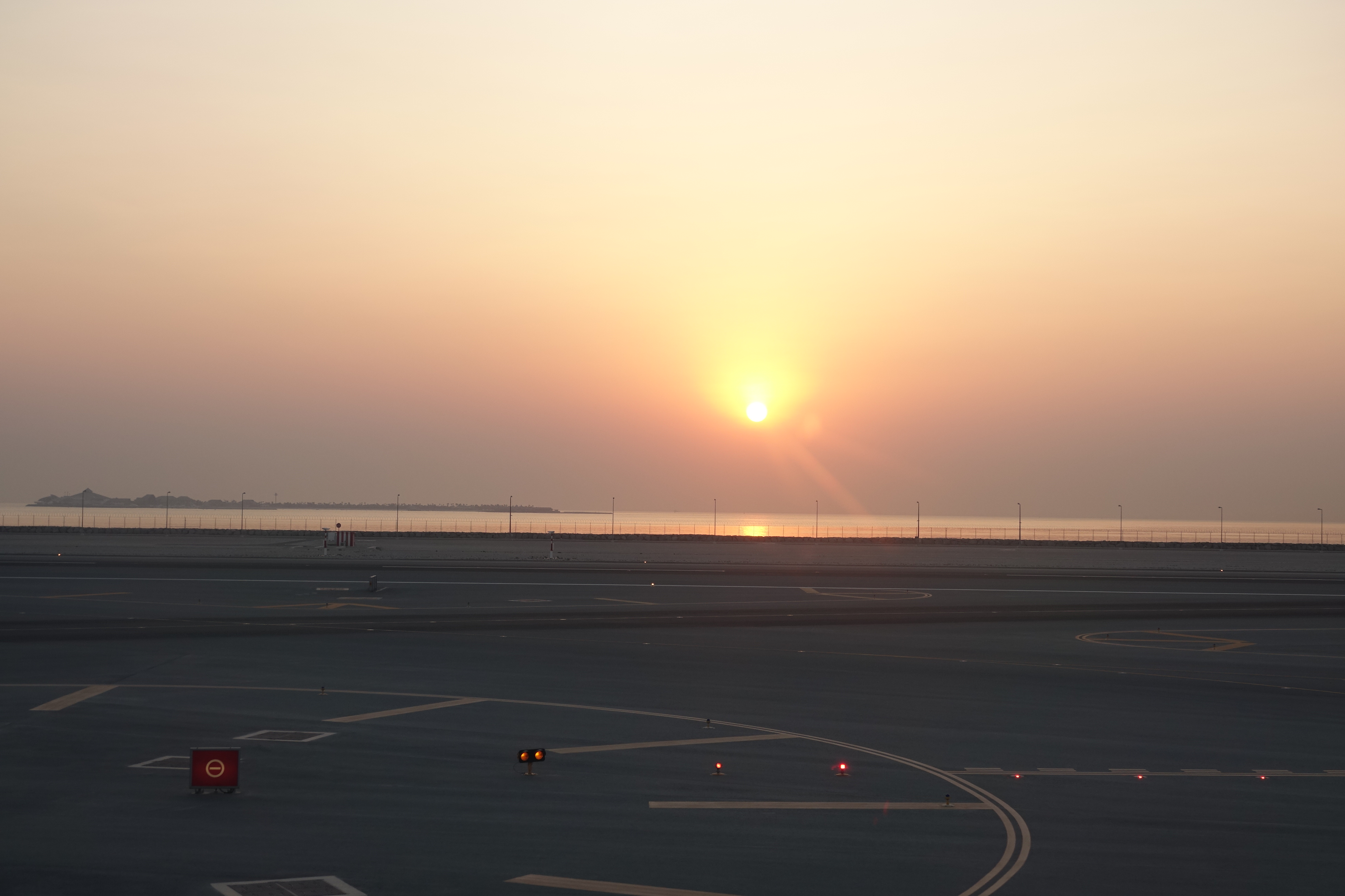 a sunset over a runway