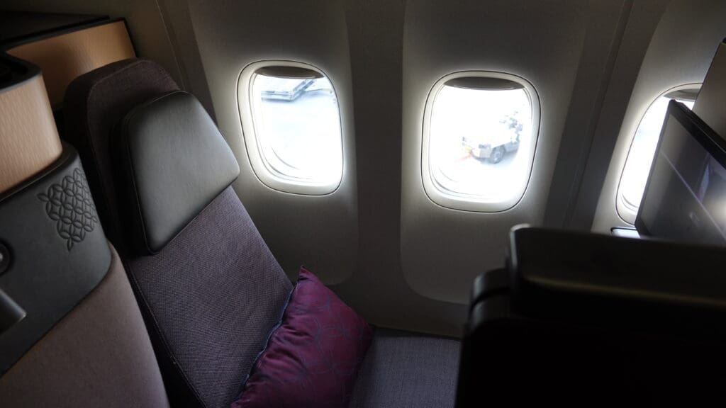 a seat with a pillow and two windows