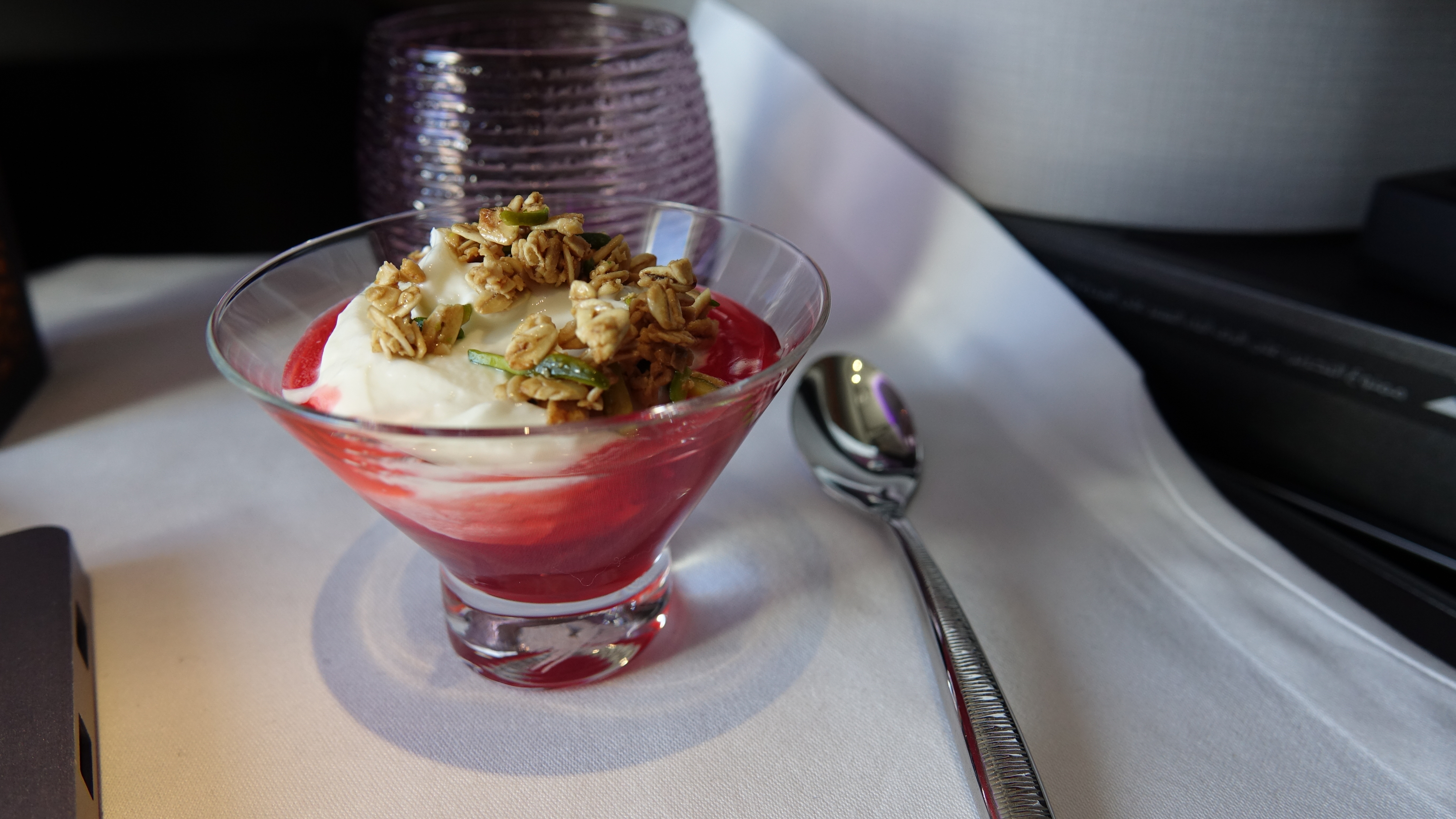 a dessert in a glass bowl with a spoon