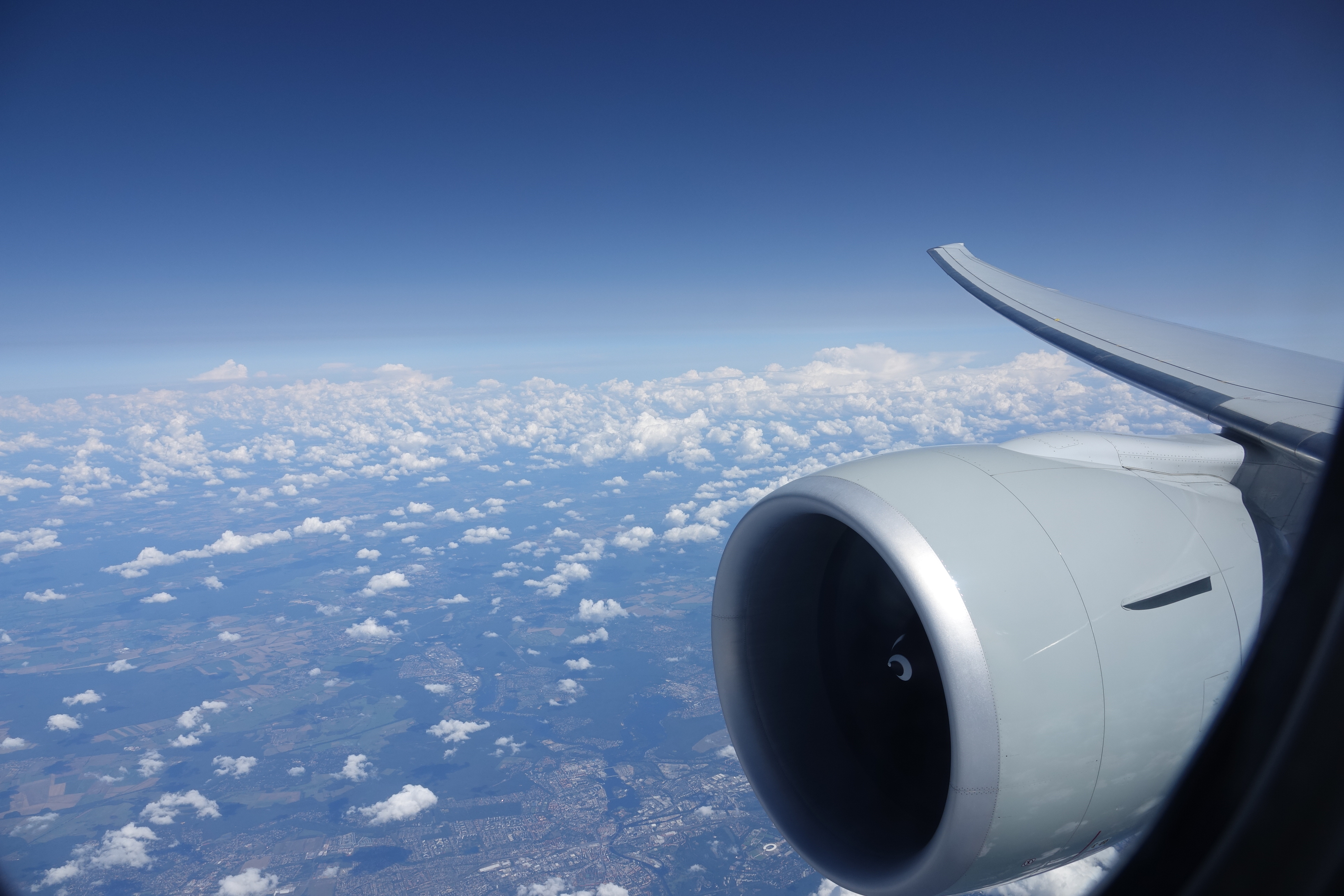 an airplane wing and a blue sky