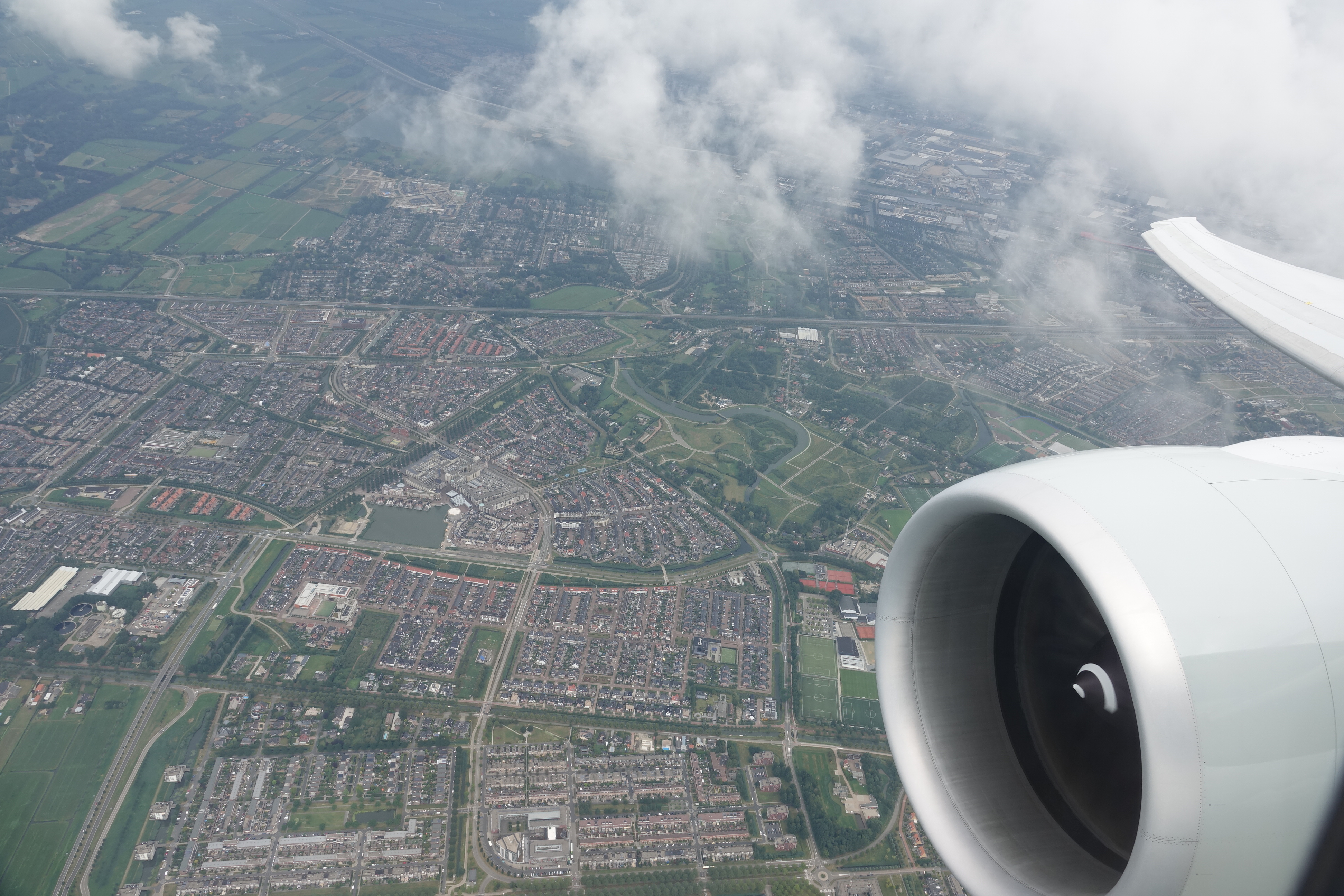 an airplane wing and a city