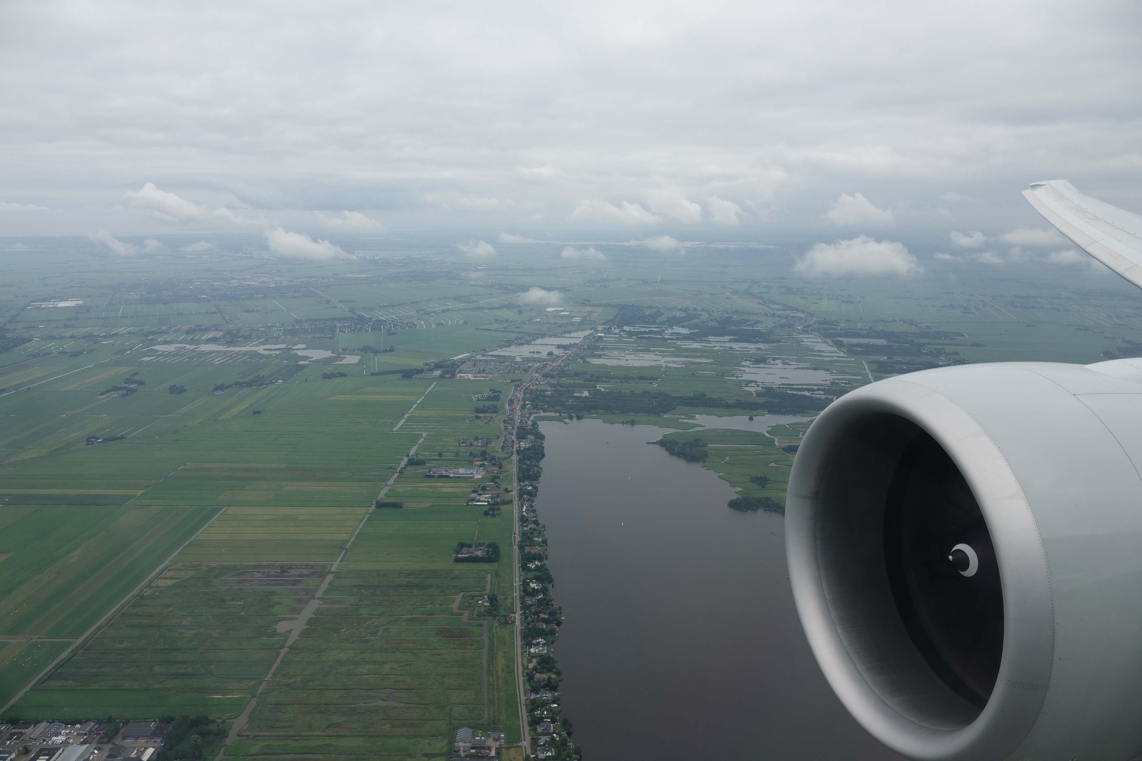 an airplane wing and a body of water